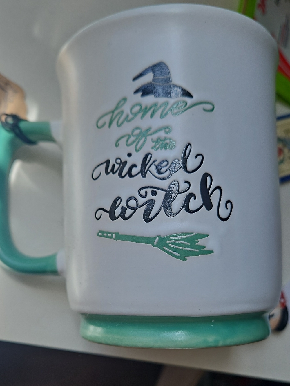 NWT White Ceramic Mug with Mint Handle - 'Home of the Wicked Witch'